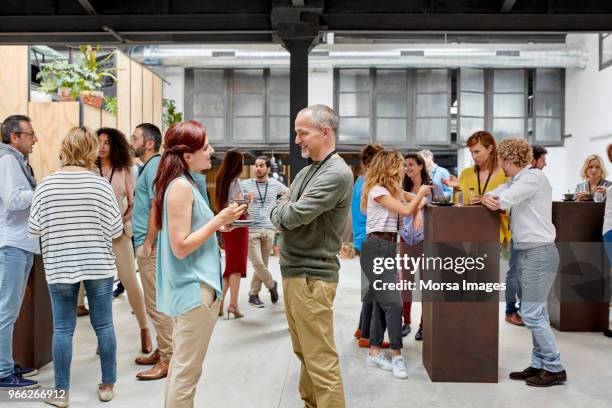 business people communicating at convention center - パイプ ストックフォトと画像