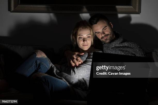 couple using laptop computer in darkroom at home - darkroom fotografías e imágenes de stock