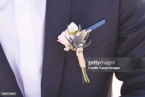 midsection of bridegroom in suit - boutonniere ストックフォトと画像
