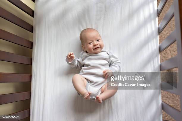 overhead portrait of baby boy in crib at home - babysäng bildbanksfoton och bilder