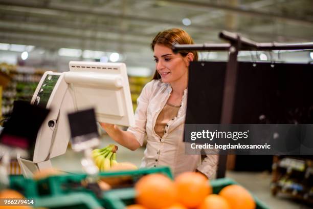 woman in supermarket - self service stock pictures, royalty-free photos & images