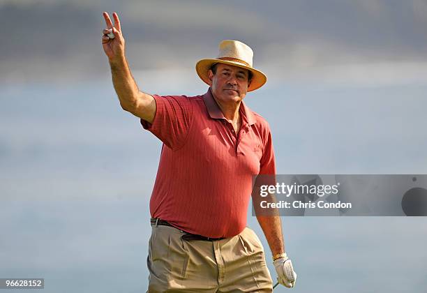 Sports announcer Chris Berman waves to the gallery on the 18th green during the second round of the AT&T Pebble Beach National Pro-Am at Pebble Beach...