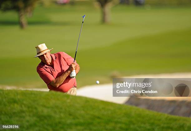 Sports announcer Chris Berman hits from a bunker on during the second round of the AT&T Pebble Beach National Pro-Am at Pebble Beach Golf Links on...