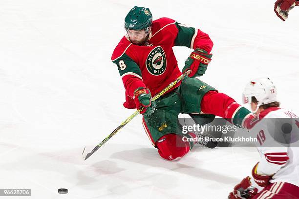 Brent Burns of the Minnesota Wild falls while attempting to clear the puck against the Phoenix Coyotes during the game at the Xcel Energy Center on...