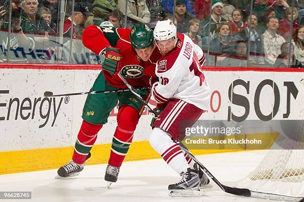 Derek Boogaard of the Minnesota Wild and Sami Lepisto of the Phoenix Coyotes fight for position during the game at the Xcel Energy Center on February...