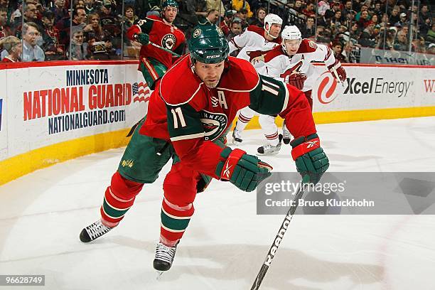 Owen Nolan of the Minnesota Wild skates to the puck against the Phoenix Coyotes during the game at the Xcel Energy Center on February 10, 2010 in...