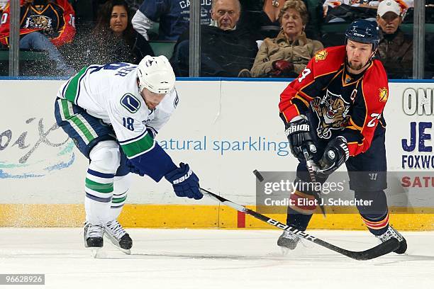 Bryan McCabe of the Florida Panthers tangles with Steve Bernier of the Vancouver Canucks at the BankAtlantic Center on February 11, 2010 in Sunrise,...