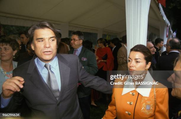 Bernard Tapie, ex-ministre de la Ville, et son epouse Dominique a la garden-party de l'Elysee le 14 juillet 1993 a Paris, France.