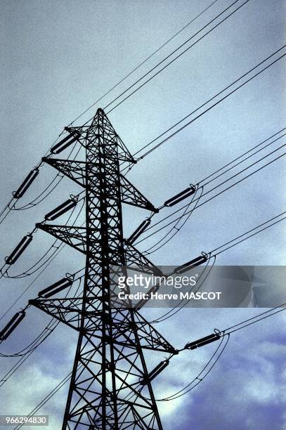 High tension electricity poles, France Pylone electrique sur fond bleu et gris en contre plongee.