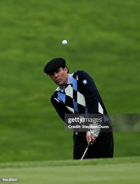 Singer Clay Walker chips onto the green on the 11th hole during the second round of the AT&T Pebble Beach National Pro-Am at Spyglass Hill Golf...