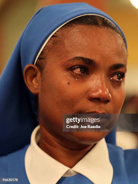 Catholic nun, Marie France Syldor cries during a prayer vigil at the Notre Dame d'Haiti Catholic church as they mark the one month anniversary of the...