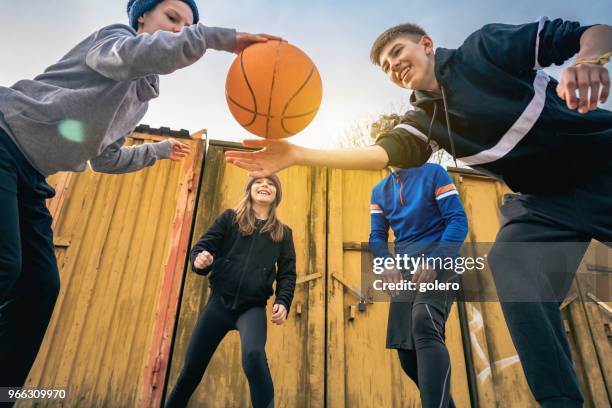 kinder spielen basketball auf straße mit vater - season 15 stock-fotos und bilder