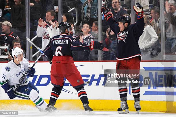 Anton Stralman congratulates Raffi Torres, both of the Columbus Blue Jackets, on his second period goal against the Vancouver Canucks on February 12,...