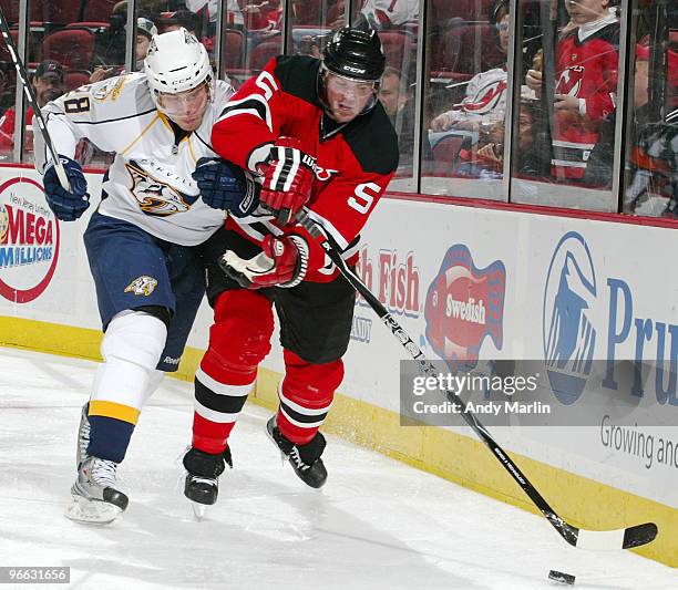 Ryan Jones of the Nashville Predators and Colin White of the New Jersey Devils battle for control of the puck during their game at the Prudential...