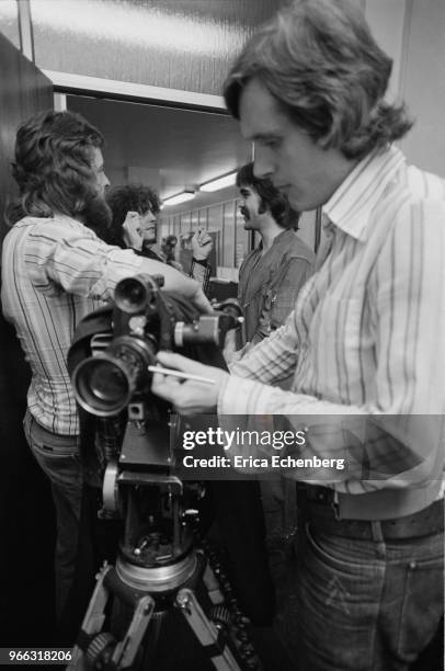 Marc Bolan with a film crew and film maker Martin Baker in Eric Hall's office at EMI records, Manchester Square, London, 1977.