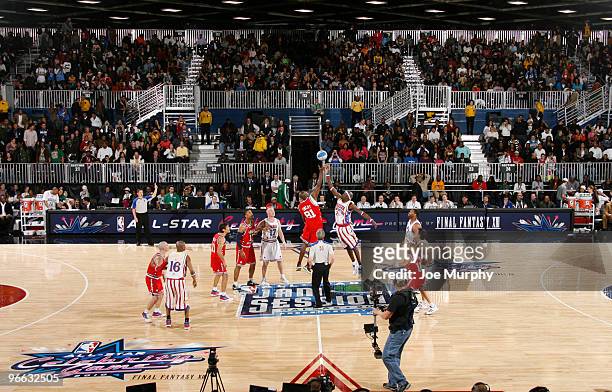 Player Terrell Owens and Harlem Globe Trotter Special K Daley tip-off during the 2010 NBA All-Star Celebrity Game presented by FINAL FANTASY XIII on...