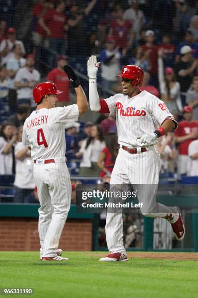 Scott Kingery of the Philadelphia Phillies high fives Aaron Altherr against the Atlanta Braves at Citizens Bank Park on May 21, 2018 in Philadelphia,...