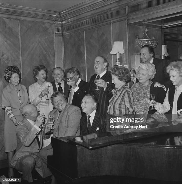 English actor John Mills with his wife, English actress and author Mary Hayley Bell and friends, including actors Robert Morley and Harry Secombe at...