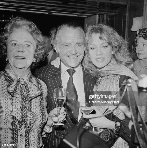 English actor John Mills at a party with his wife, English actress and author Mary Hayley Bell and daughter, English actress Hayley Mills, UK, 1st...