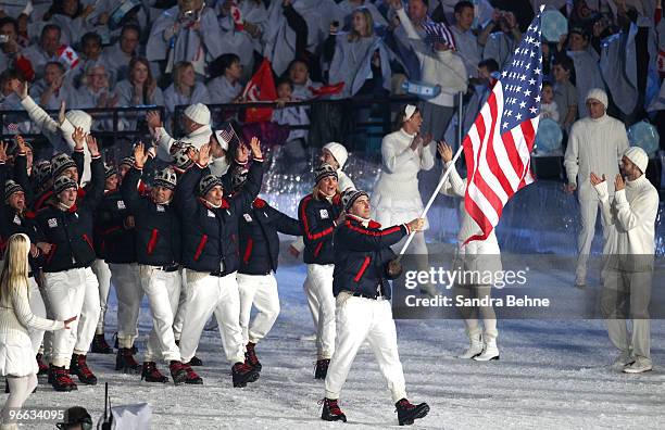 United States flag bearer Mark Grimmette leads in the US Olympic team during the Opening Ceremony of the 2010 Vancouver Winter Olympics at BC Place...