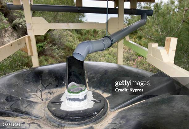 europe, greece, 2018: view of plastic drain pipe directing rain water into storage tank - rainwater tank stock pictures, royalty-free photos & images