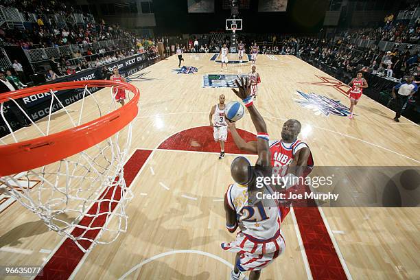 Player Terrell Owens shoots the ball over Harlem Globe Trotter Special K Daley during the 2010 NBA All-Star Celebrity Game presented by FINAL FANTASY...