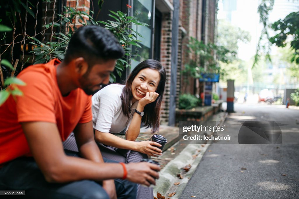 Friends chatting outdoors in Kuala Lumpur, Malaysia