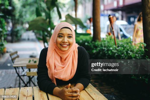 portrait of a malaysian woman on the cafe in kuala lumpur - islam woman stock pictures, royalty-free photos & images