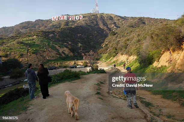 With one letter remaining, activists continue covering the iconic 450-foot-long Hollywood sign with banners during an effort to prevent the building...