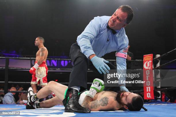 Gabriel Bracero celebrates as referee Arthur Mercante tends to Danny O'Connor at the Lowell Memorial Auditorium in Lowell, MA on October 10, 2015....