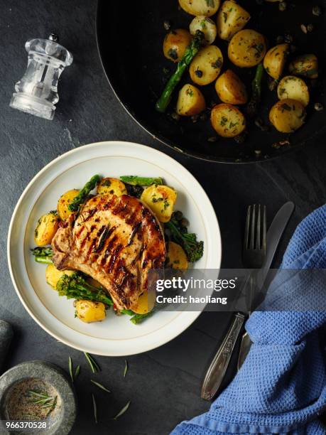 grilled pork chop with garlic sauté potatoes - pork chop stock pictures, royalty-free photos & images