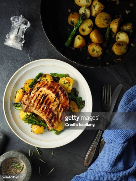 grilled pork chop with garlic sauté  potatoes - haoliang stock pictures, royalty-free photos & images