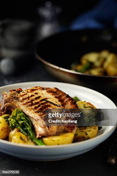 grilled pork chop with garlic sauté  potatoes - haoliang stock pictures, royalty-free photos & images
