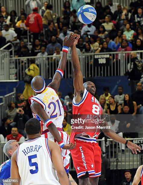 Player Robert Horry, Special K Daley of the Harlem Globetrotters, and NFL player Terrell Owens play on the court during the NBA All-Star celebrity...