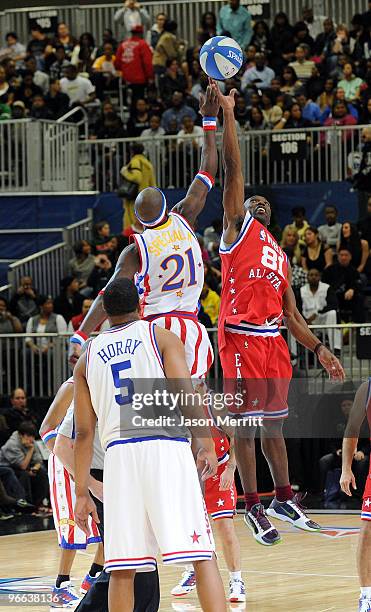 Player Robert Horry, Special K Daley of the Harlem Globetrotters, and NFL player Terrell Owens play on the court during the NBA All-Star celebrity...