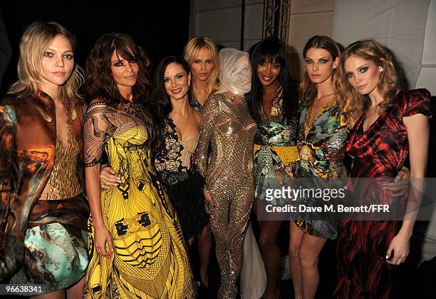 Models Sasha Pivovarova , Helena Christensen , Daphne Guinness , and Naomi Campbell pose wearing Alexander McQueen backstage at Naomi Campbell's...