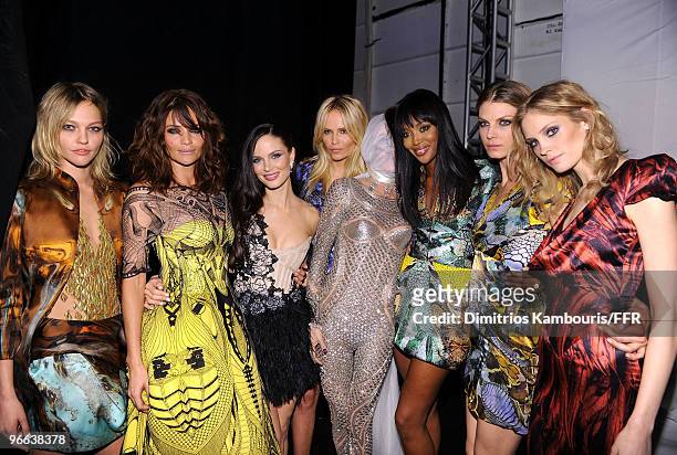 Models Sasha Pivovarova , Helena Christensen , Daphne Guinness , and Naomi Campbell pose wearing Alexander McQueen backstage at Naomi Campbell's...