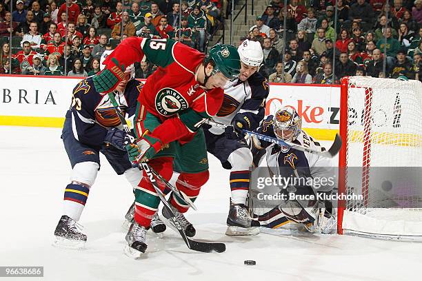 Andrew Brunette of the Minnesota Wild handles the puck while being defended by Tobias Enstrom, Marty Reasoner, Johan Hedberg # of the Atlanta...