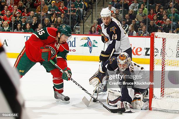 Andrew Brunette of the Minnesota Wild attempts to score but is stopped by goalie Johan Hedberg and Marty Reasoner of the Atlanta Thrashers during the...