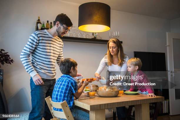 mother serving food to her family, munich, germany - abendbrot stock-fotos und bilder