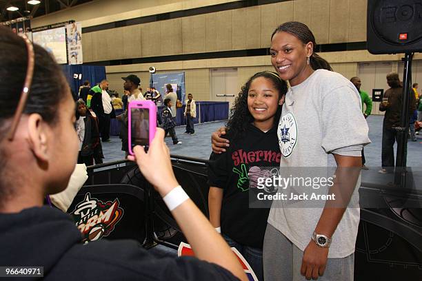 Asjha Jones of the WNBA Connecticut Sun poses for a picture with a fan during Jam Session presented by Adidas during All Star Weekend on February 12,...