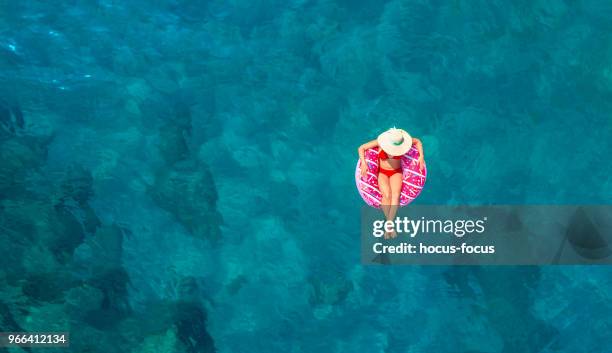 swimming in clear turquoise sea - pool raft stock pictures, royalty-free photos & images