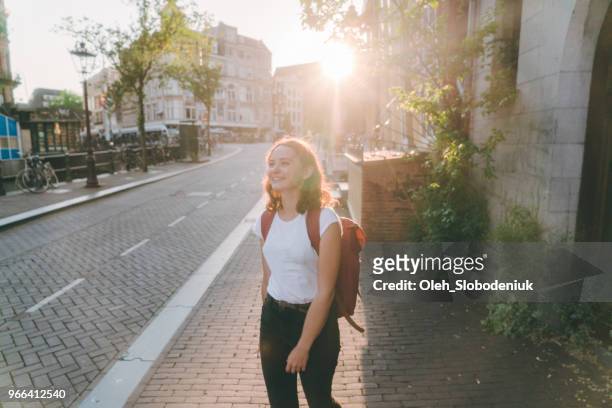 woman walking on the streets  of amsterdam - amsterdam spring stock pictures, royalty-free photos & images