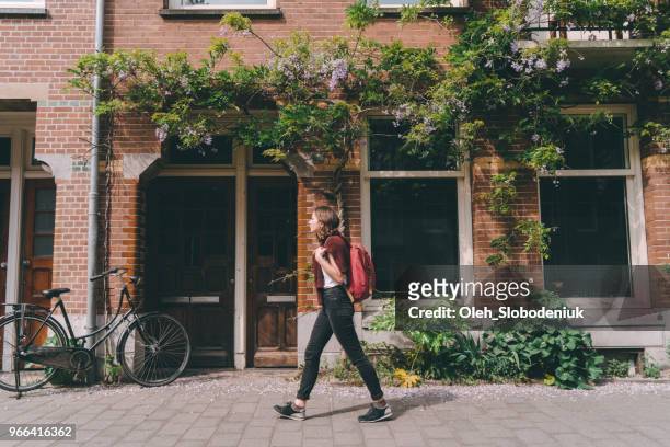 woman walking on the streets  of amsterdam - dutch culture stock pictures, royalty-free photos & images