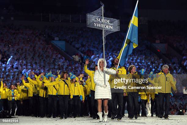 Peter Forsberg of Sweden carries his national flag into the stadium during the Opening Ceremony of the 2010 Vancouver Winter Olympics at BC Place on...
