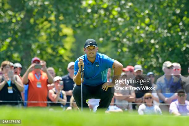 Patrick Reed looks over his putt at the second hole during the third round of the Memorial Tournament presented by Nationwide at Muirfield Village...