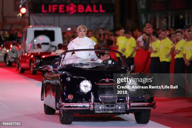 Conchita Wurst is seen riding in the back of a oldtimer during the Life Ball 2018 show at City Hall on June 2, 2018 in Vienna, Austria. The Life...