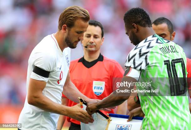 Captain Harry Kane of England swaps pennants with John Obi Mikel of Nigeria before the International Friendly match between England and Nigeria at...
