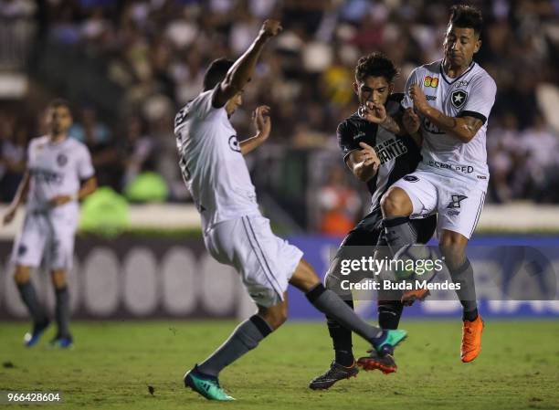 Henrique of Vasco da Gama struggles for the ball with Leo Valencia of Botafogo during a match between Vasco da Gama and Botafogo as part of...