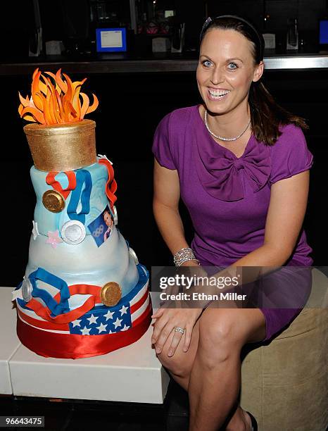 United States Olympic swimmer and model Amanda Beard appears with an Olympic-themed cake as she hosts a viewing party at Lagasse's Stadium at The...